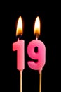 Burning candles in the form of 189 nineteen figures numbers, dates for cake isolated on black background. The concept of celebra