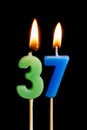 Burning candles in the form of 36 thirty six numbers, dates for cake isolated on black background. The concept of celebrating a Royalty Free Stock Photo