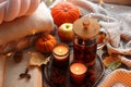 Burning candles, freshly brewed tea, sweaters, book and autumn decor on fabric Royalty Free Stock Photo