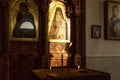 Burning candles in front of icons in the Armenian church in the sunlight. Close-up