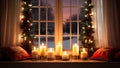 Burning candles in front of a window with a Christmas wreath Royalty Free Stock Photo