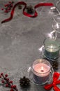 Burning candles with garland, mistletoe, pine cones, red bow and Royalty Free Stock Photo