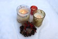 Burning candles in glass candlesticks and Christmas bells