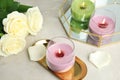 Burning candles in glass holders and roses Royalty Free Stock Photo