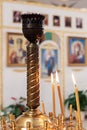 Burning candles in a golden candlestick. Church of Saint Panteleimon the Healer, Khmelnitsky, Ukraine - 27 november 2021