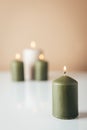 Burning candles in green and beige colors Royalty Free Stock Photo