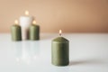 Burning candles in green and beige colors Royalty Free Stock Photo