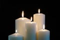 Burning candles isolated on black background.