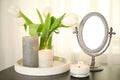 Burning candles, mirror and flowers on black table indoors Royalty Free Stock Photo
