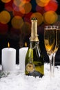 Burning candles near an open bottle of champagne Royalty Free Stock Photo