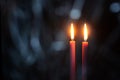 Burning candles at Night. Two red candles on dark background with bokeh effect Royalty Free Stock Photo