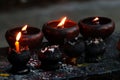 Burning candles and oil lamps in a buddhist temple in Thailand Royalty Free Stock Photo