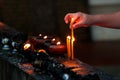 Burning candles and oil lamps in a buddhist temple in Thailand Royalty Free Stock Photo