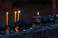 Burning candles and oil lamps in a buddhist temple in Thailand Royalty Free Stock Photo