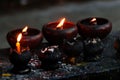 Burning candles and oil lamps in a buddhist temple in Thailand Royalty Free Stock Photo