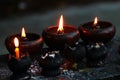 Burning candles and oil lamps in a buddhist temple in Thailand Royalty Free Stock Photo