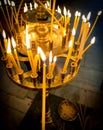 Burning candles with one lighted candle in orthodox church.