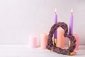 Burning candles in pastel colors and heart on white textured b Royalty Free Stock Photo