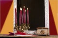 Burning candles reflected in the mirror, paper and feather. Royalty Free Stock Photo