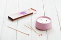 Burning candles and scattered matches on a wooden table Royalty Free Stock Photo