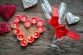 Burning candles in the shape of heart with two flutes Royalty Free Stock Photo