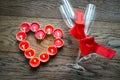 Burning candles in the shape of heart with two flutes Royalty Free Stock Photo