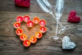 Burning candles in the shape of heart with two flutes Royalty Free Stock Photo