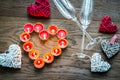 Burning candles in the shape of heart with two flutes Royalty Free Stock Photo