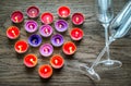 Burning candles in the shape of heart with two flutes Royalty Free Stock Photo