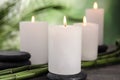 Burning candles, spa stones and bamboo sprouts on grey table against blurred Royalty Free Stock Photo