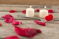 Burning candles surrounded with aromatic rose petals