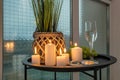 Burning candles on a table with flowers with glasses or fruits, intimate romantic atmosphere