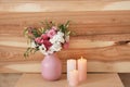 Burning candles and vase with flowers on table Royalty Free Stock Photo