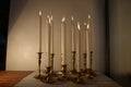 Burning candles in retro candlesticks indoor Royalty Free Stock Photo