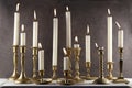 Burning candles in vintage metal candlesticks on white wooden table against dark stone background. Royalty Free Stock Photo