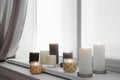 Burning candles on window sill Royalty Free Stock Photo