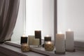 Burning candles on window sill Royalty Free Stock Photo