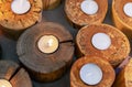 Burning candles in wooden candlesticks. Bright warm glow from candle flames Royalty Free Stock Photo