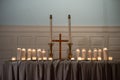 Burning candles and a wooden cross on church altar Royalty Free Stock Photo