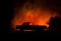 Burning car on a dark background. Car catching fire, after act of vandalism or road indicent Royalty Free Stock Photo