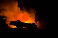 Burning car on a dark background. Car catching fire, after act of vandalism or road indicent Royalty Free Stock Photo