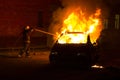 Burning car on the road in the night Royalty Free Stock Photo