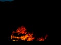 Burning car on the road at night, a tragic accident ending with Royalty Free Stock Photo