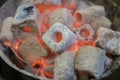 Burning charcoal briquettes glow red Royalty Free Stock Photo