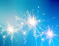 Burning christmas sparkler on blue background Royalty Free Stock Photo
