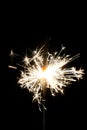 Burning christmas sparkler isolated on black background