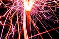 Burning christmas sparklers with long exposure. Beautiful sparkler firework flame on black background. Blurred lights of firework. Royalty Free Stock Photo