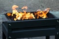 Burning coals and flame in brazier on picnic Royalty Free Stock Photo