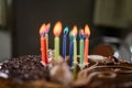 Burning colored candles on a holiday cake, the child`s tenth anniversary Royalty Free Stock Photo