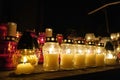 Burning colorful candles in jars in the cemetery on the occasion souls of the deceased at night Poland Religion